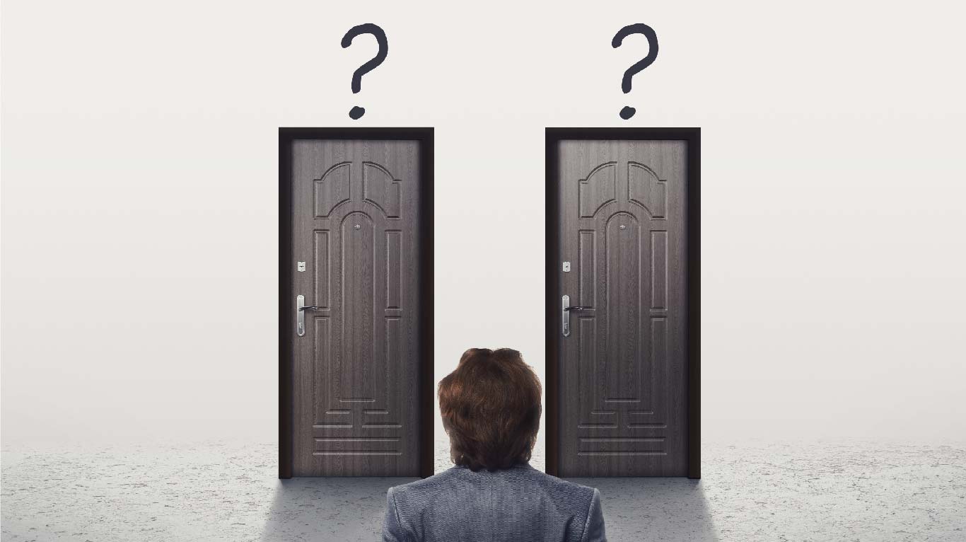 Confused man in suit looking at two similar doors